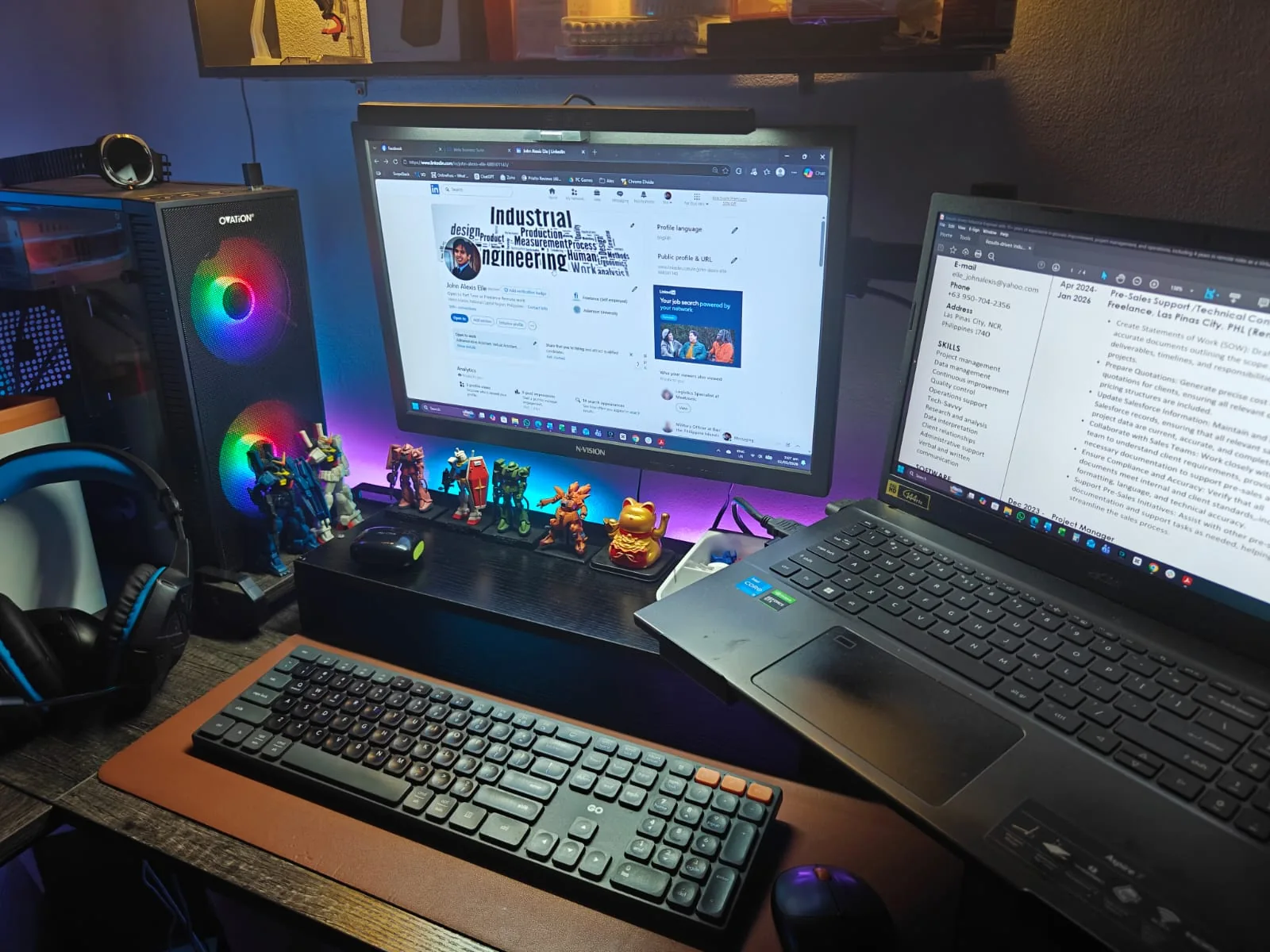 Alex’s desktop and laptop setup with a keyboard, headset, and monitors